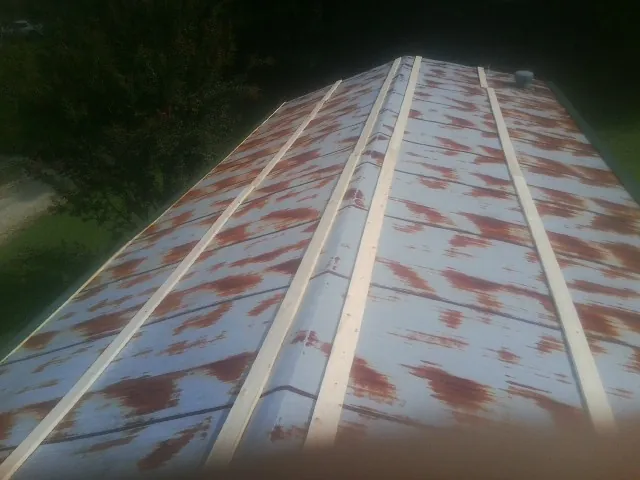 Rusted metal roof panels with new wood purlins before replacement — Storm Damage Roof Repair in Cape Girardeau by Roofing Brothers