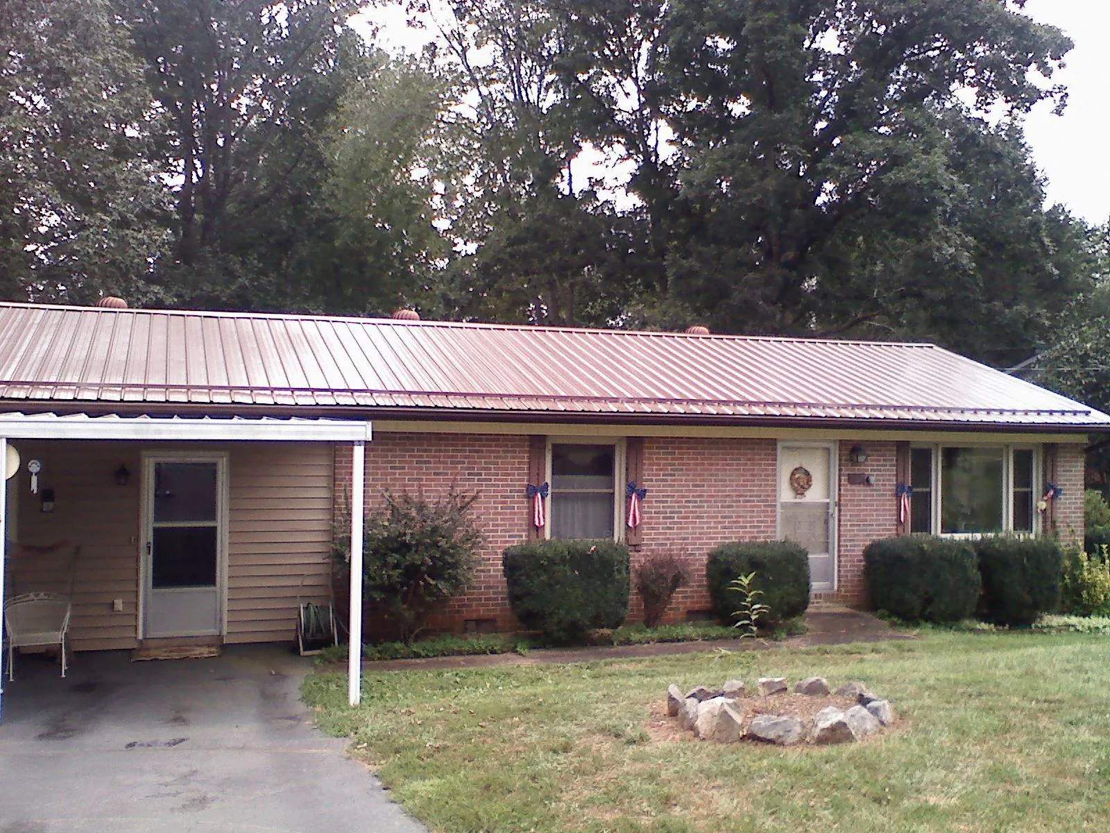 Bronze metal roof and carport on a brick ranch home — Roof Repair work by our crew in Cape Girardeau