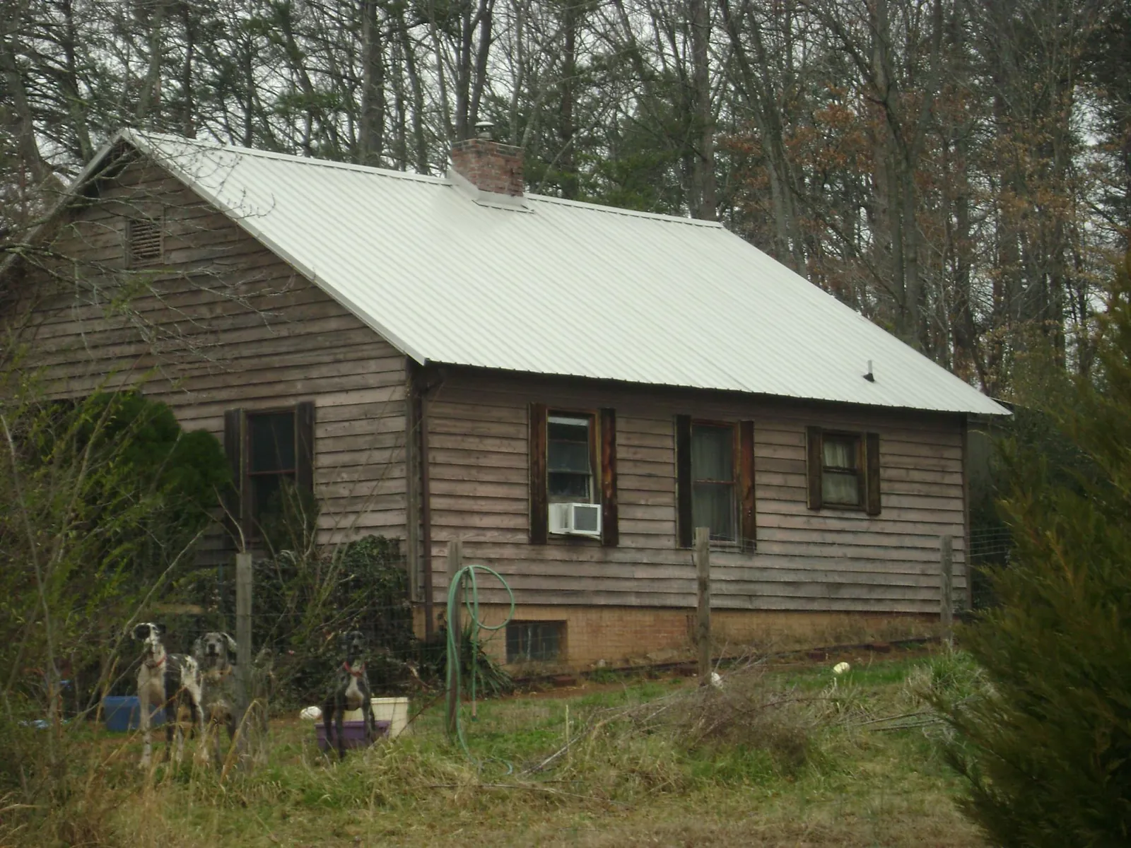 White metal roof on an old wood sided farmhouse, from a Metal Roof Installation job in Cape Girardeau